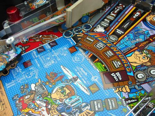The Adventures insert banner and the upper blueprint on a real playfield.