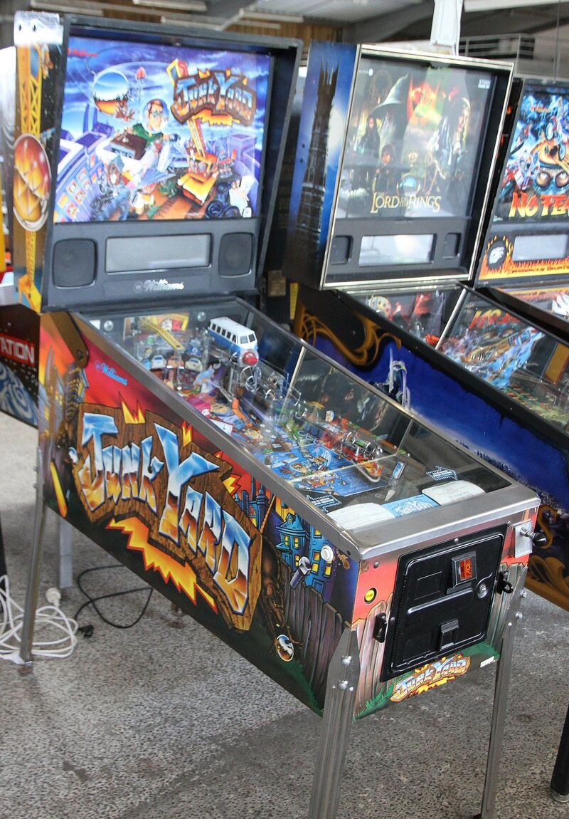 A complete Junk Yard machine with its lit backglass.