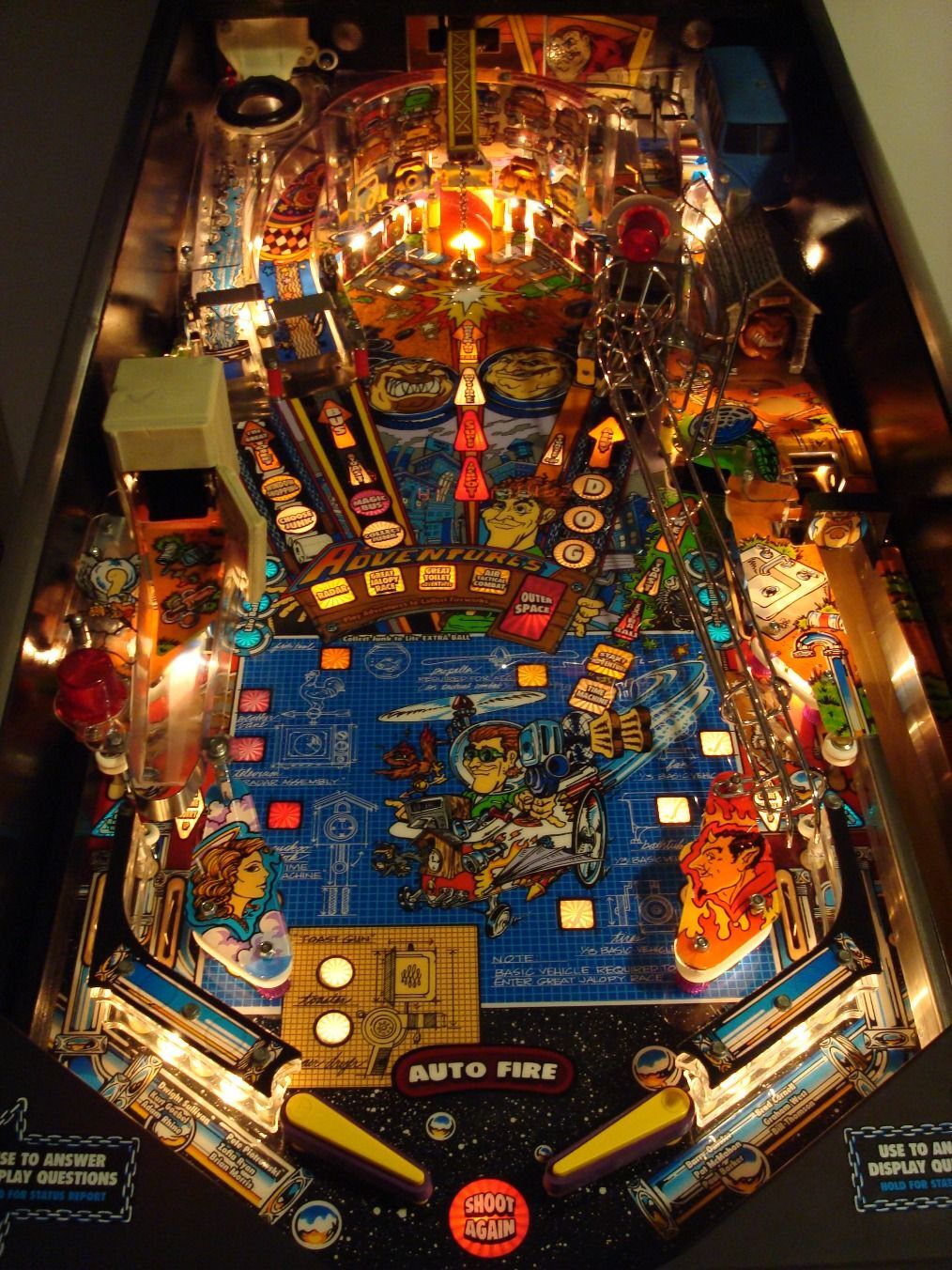 A real Junk Yard playfield lit in a dark room, inserts glowing.