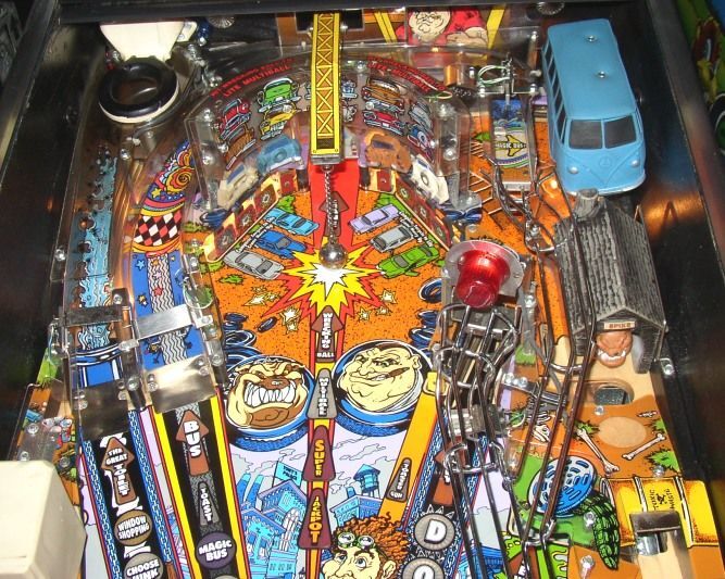 The upper playfield of a real machine: the Magic Bus, the red beacon and the wire ramps toward Spike Alley.