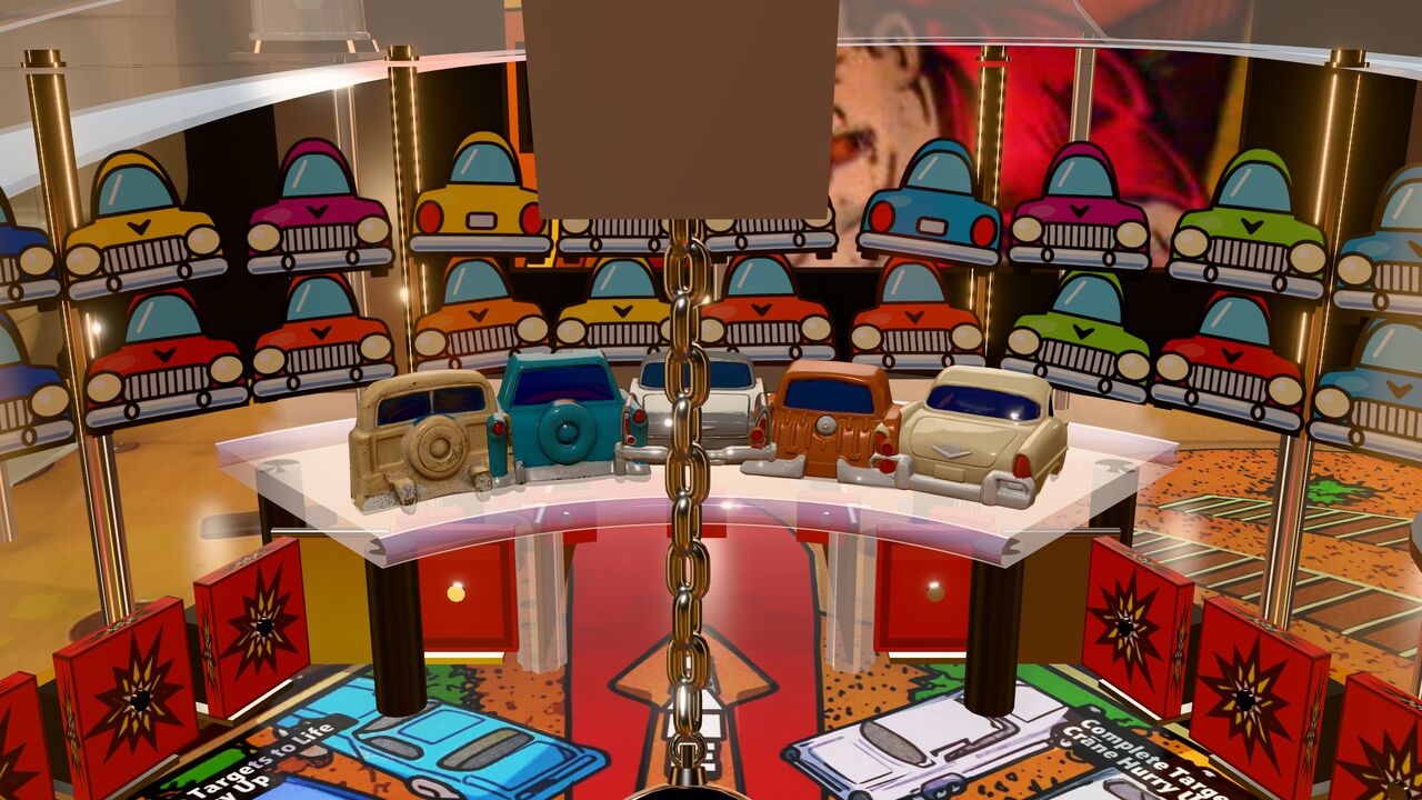 The five car targets in our game: rear ends of cream, teal, silver, rust-orange and cream cars behind the chain.